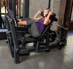 woman using Glutebuilder Glute Press plate loaded